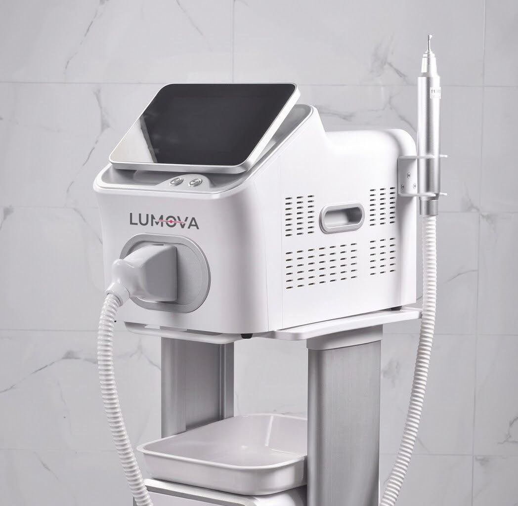 Lumova Q-switched Nd:YAG laser on a treatment trolley, with touchscreen and laser handpiece in its holder